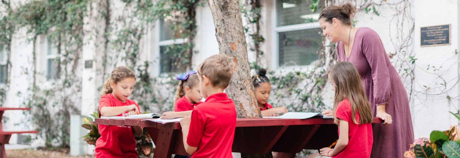 LS PLA Group Outside on Red Picnic Tables